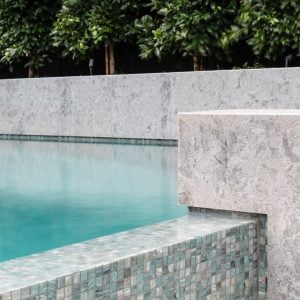 Pool tiles surrounding a Feature Pools concrete swimming pool build